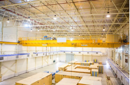 overhead crane in a warehouse full of cargo containers