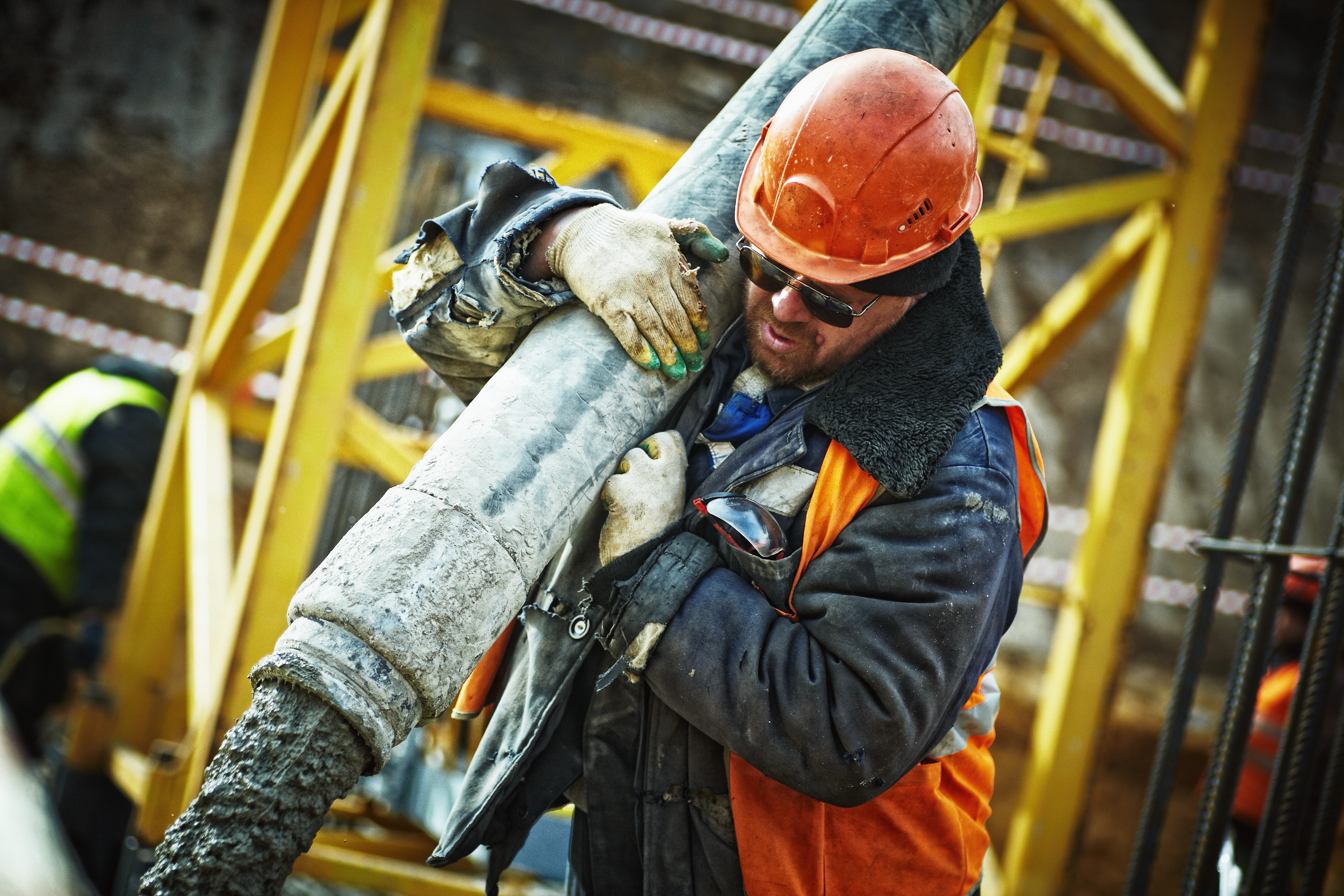 A factory worker carrying products up the warehouse steps. 